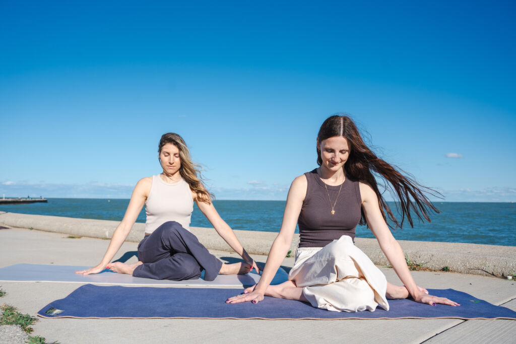 Two women meditating by the lake, learning how to practice self therapy